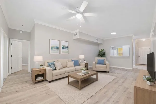a living room with furniture a flat screen tv and a fireplace