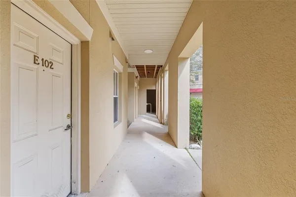a view of a hallway with wooden shelves