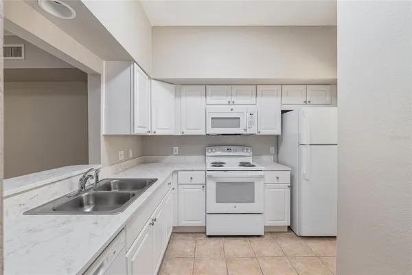 a kitchen with a sink a stove and refrigerator
