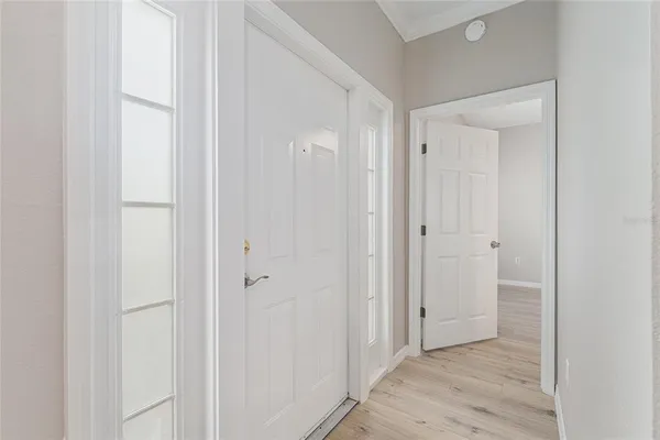 a view of a hallway with wooden floor
