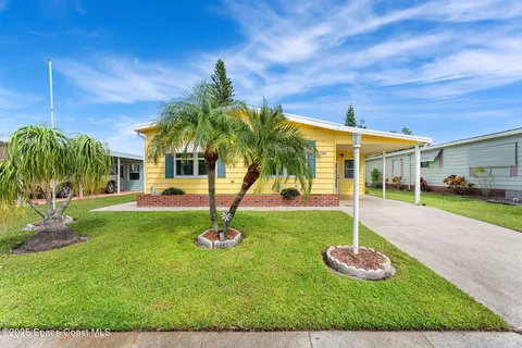 a view of a house with a backyard porch and sitting area