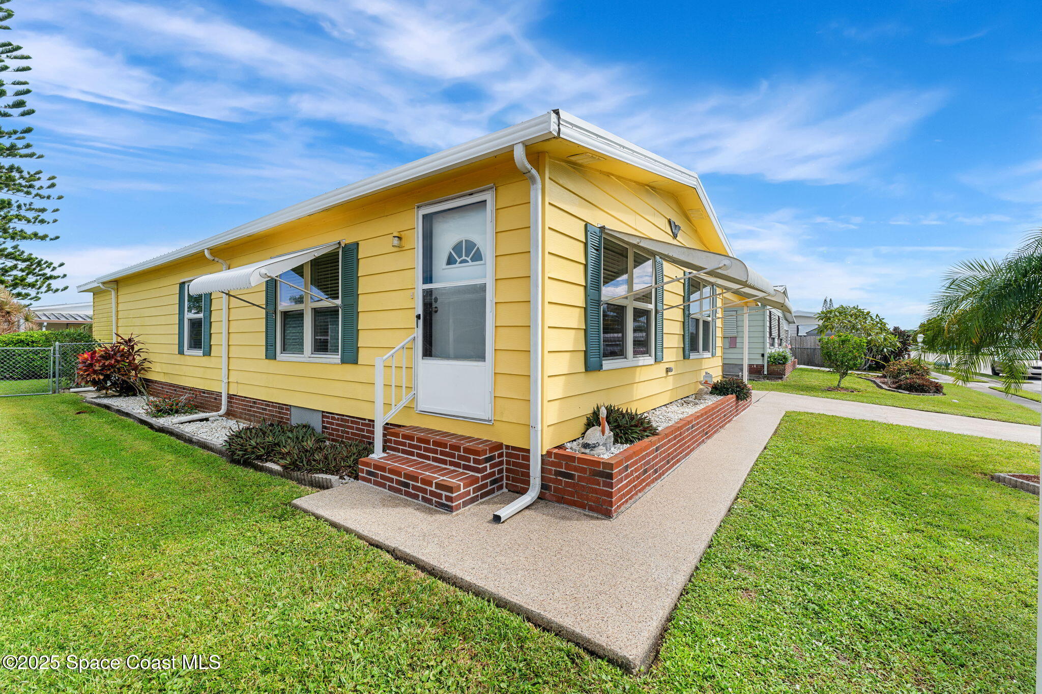 1885 Mango Street Northeast Palm Bay, FL 32905 - Photo 26 of 36 a front view of a house with a yard