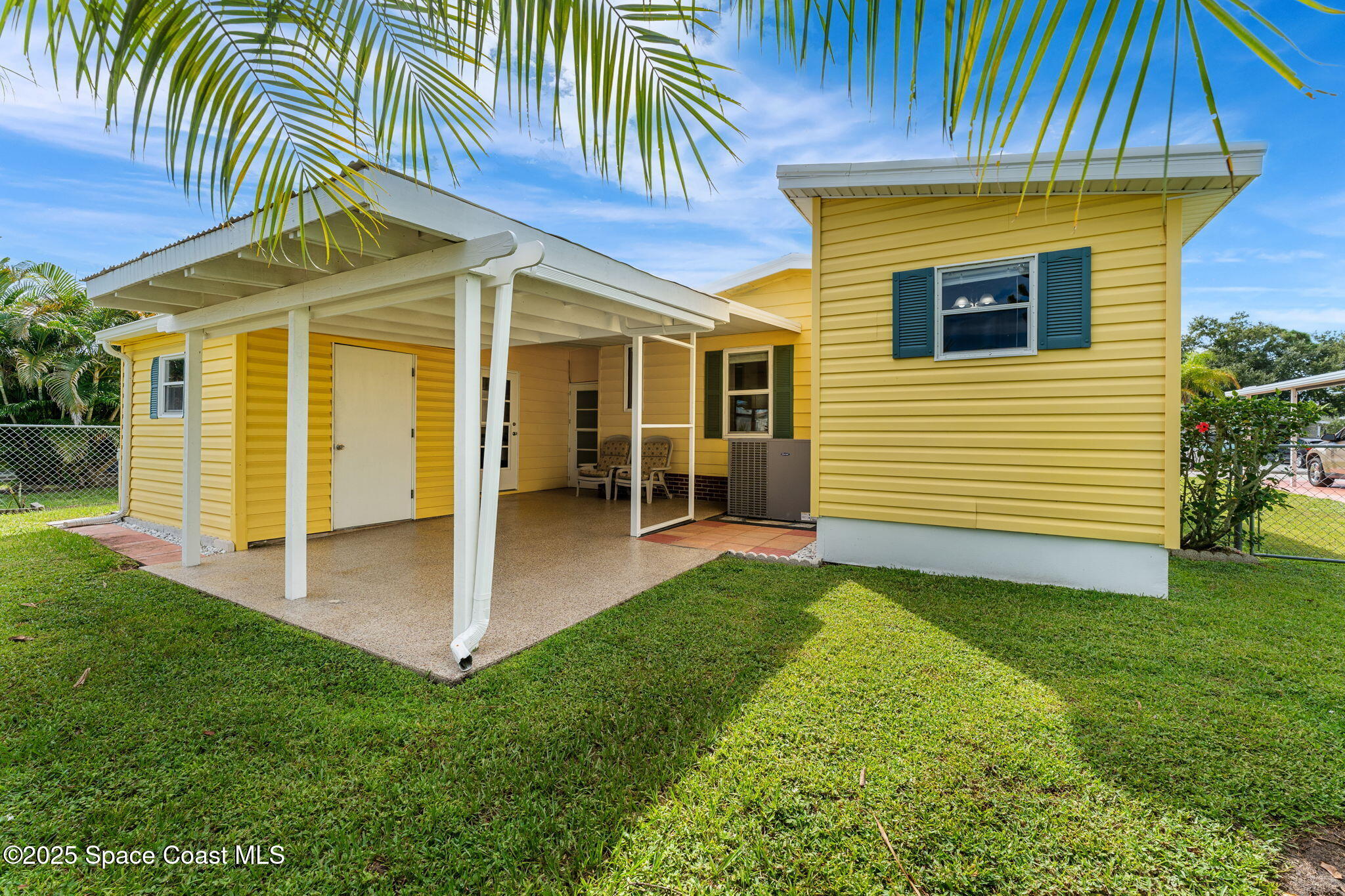 1885 Mango Street Northeast Palm Bay, FL 32905 - Photo 3 of 36 a view of a house with a yard and furniture
