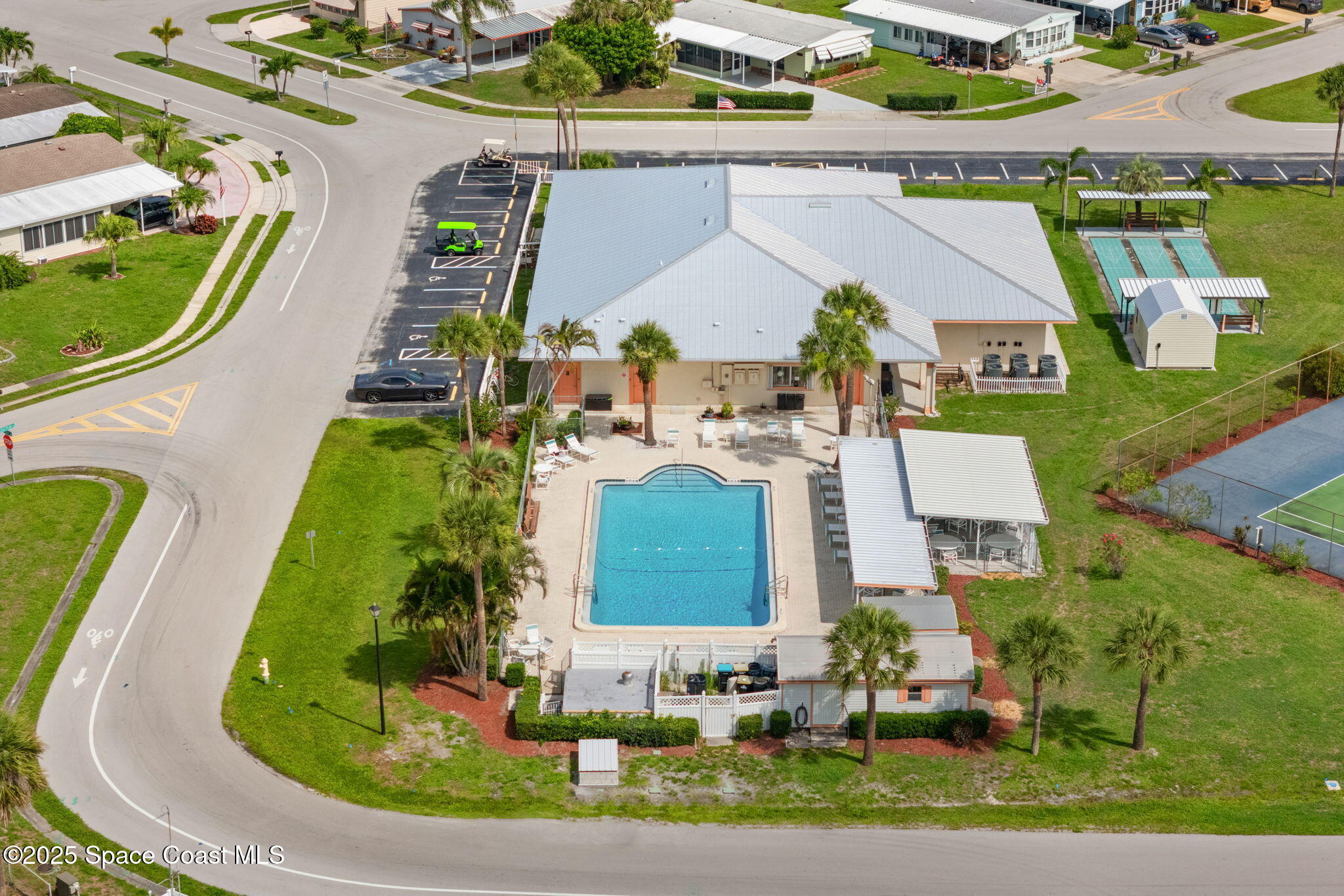 1885 Mango Street Northeast Palm Bay, FL 32905 - Photo 34 of 36 an aerial view of a house with a garden and swimming pool