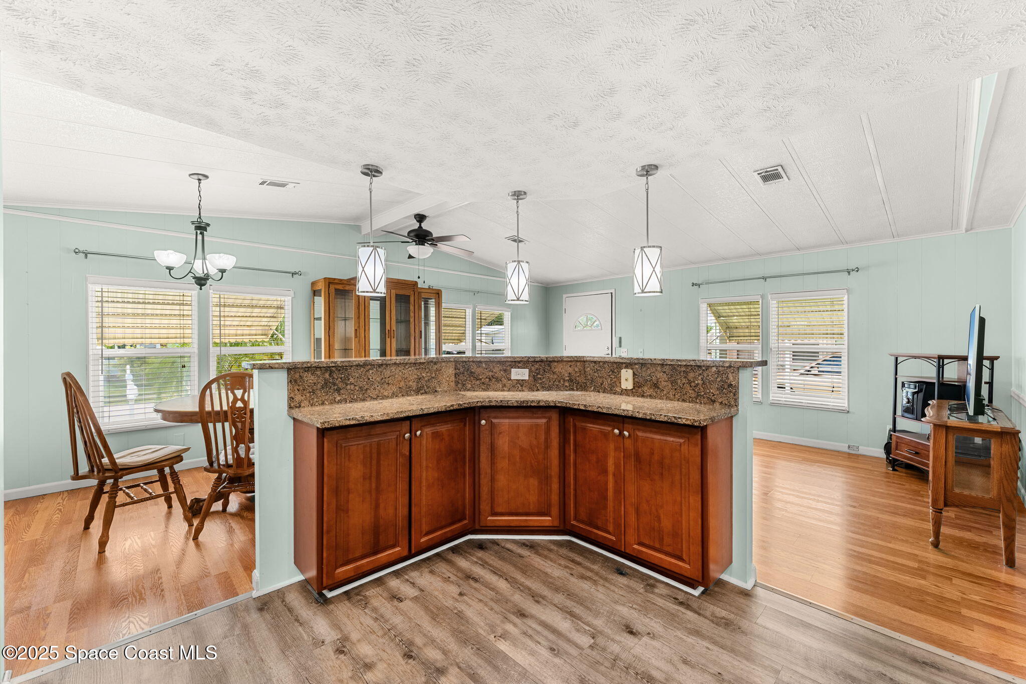 1885 Mango Street Northeast Palm Bay, FL 32905 - Photo 7 of 36 a open kitchen with stainless steel appliances granite countertop a stove and wooden floor