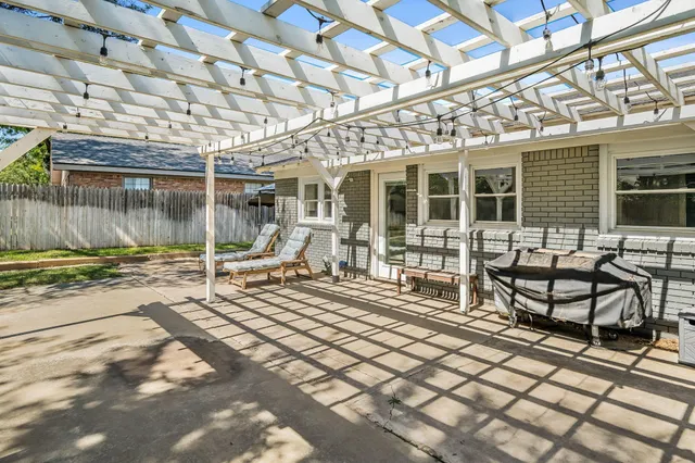 a view of a house with backyard porch and sitting area