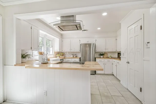 a kitchen with stainless steel appliances granite countertop a sink and cabinets