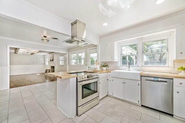 a kitchen with stainless steel appliances granite countertop a stove and a sink