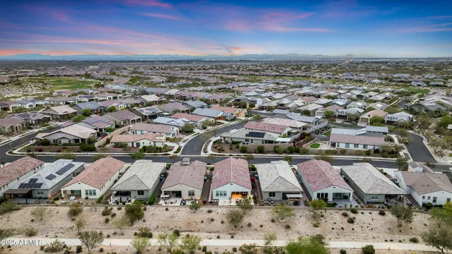 a view of a swimming pool with tables and chairs