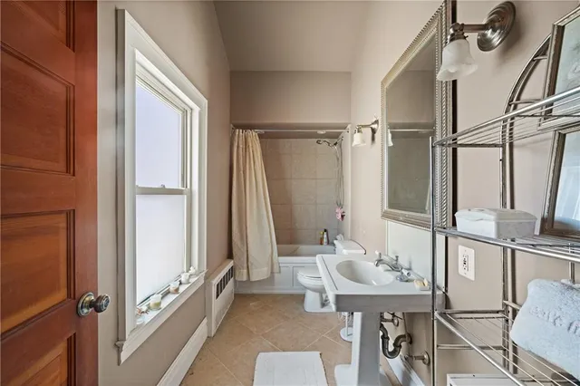 a bathroom with a tub a sink and a mirror
