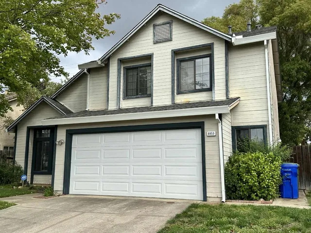 a front view of a house with a garage