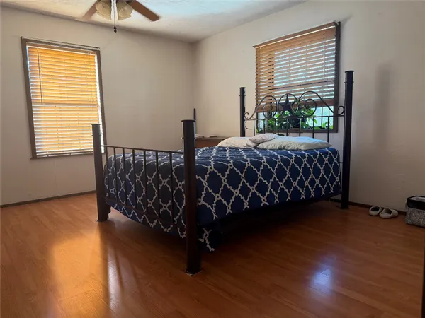 a bed sitting in a bedroom next to a window