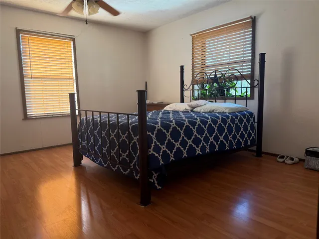 a bed sitting in a bedroom next to a window