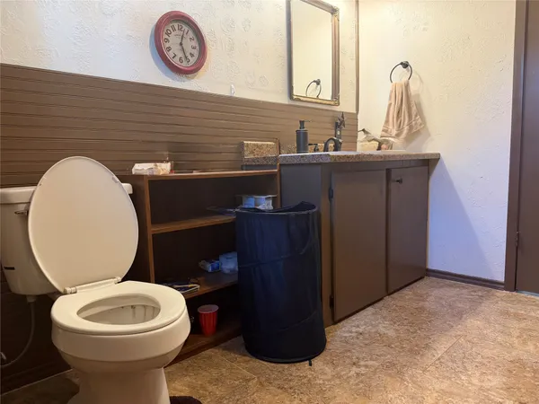 a bathroom with a toilet a sink and a mirror