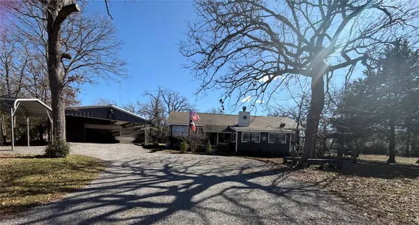 a front view of a house with a yard covered in snow