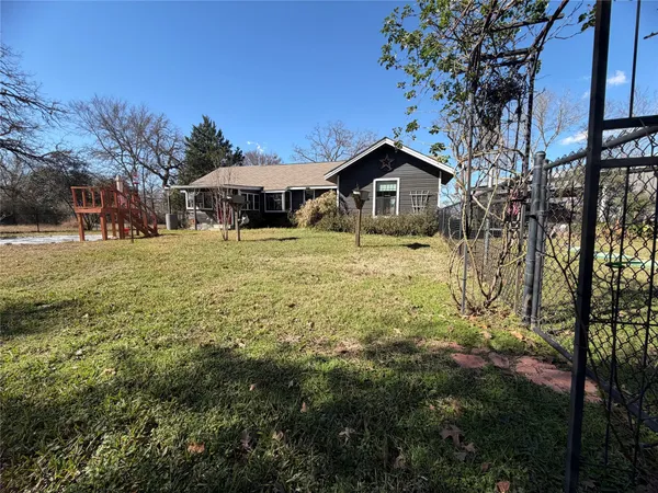 a yellow house in middle of the forest