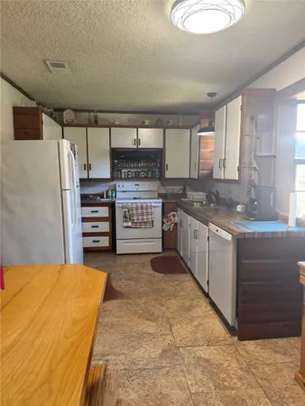 a kitchen with stainless steel appliances a stove a sink and a refrigerator