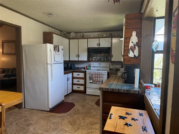 a kitchen with stainless steel appliances granite countertop a refrigerator and a stove