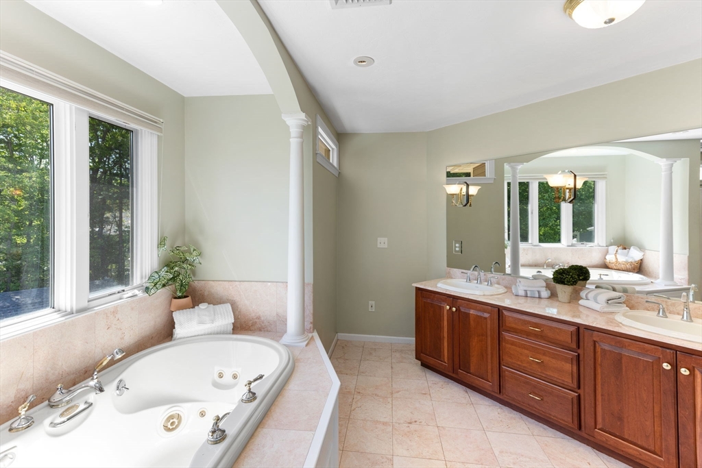 5 Linden Glen Road Canton, MA 02021 - Photo 24 of 42 a bathroom with a granite countertop tub sink and mirror