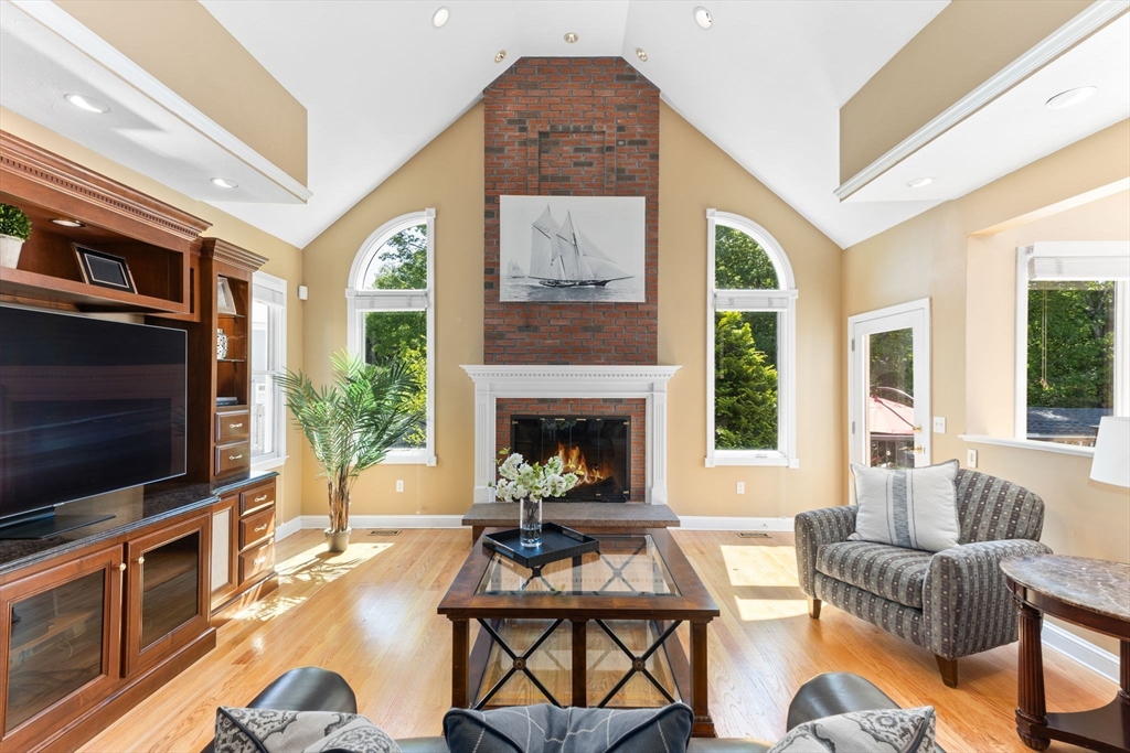 5 Linden Glen Road Canton, MA 02021 - Photo 9 of 42 a living room with furniture a flat screen tv and a fireplace