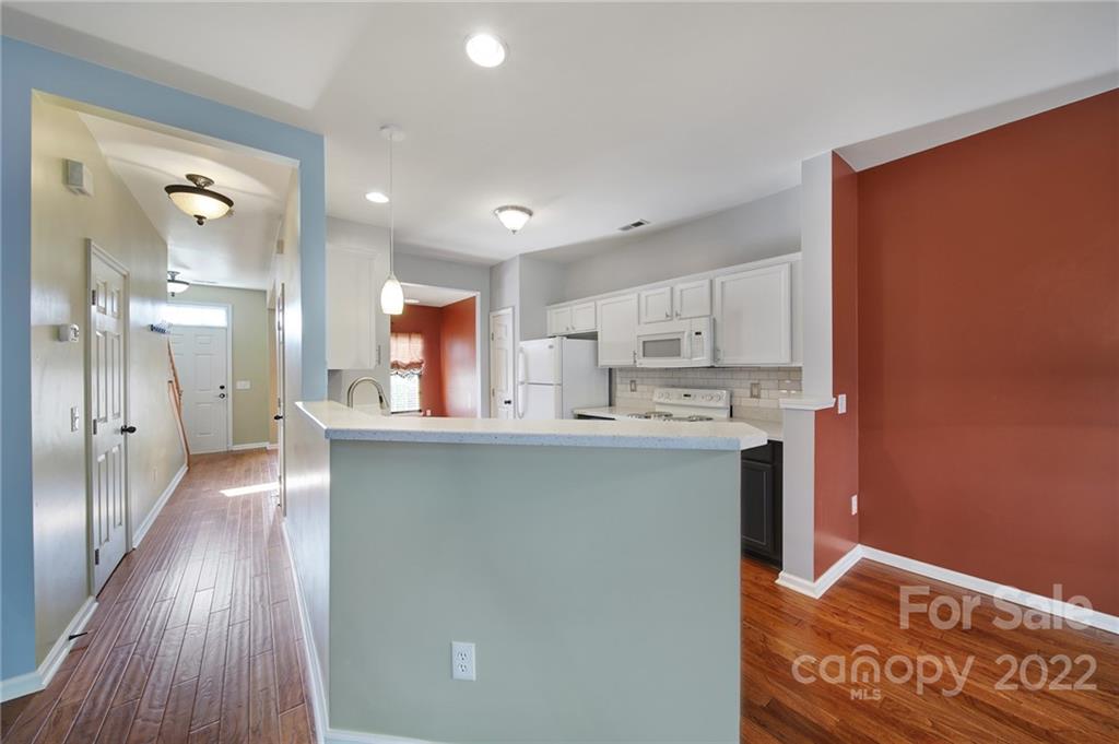 618 Bayou Circle Clover, SC 29710 - Photo 12 of 37 a kitchen with stainless steel appliances granite countertop a refrigerator a sink and wooden floors