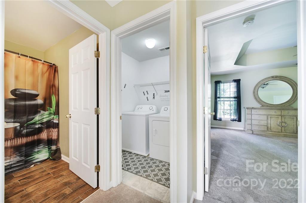 618 Bayou Circle Clover, SC 29710 - Photo 22 of 37 a bathroom with a sink a mirror a glass door and shower