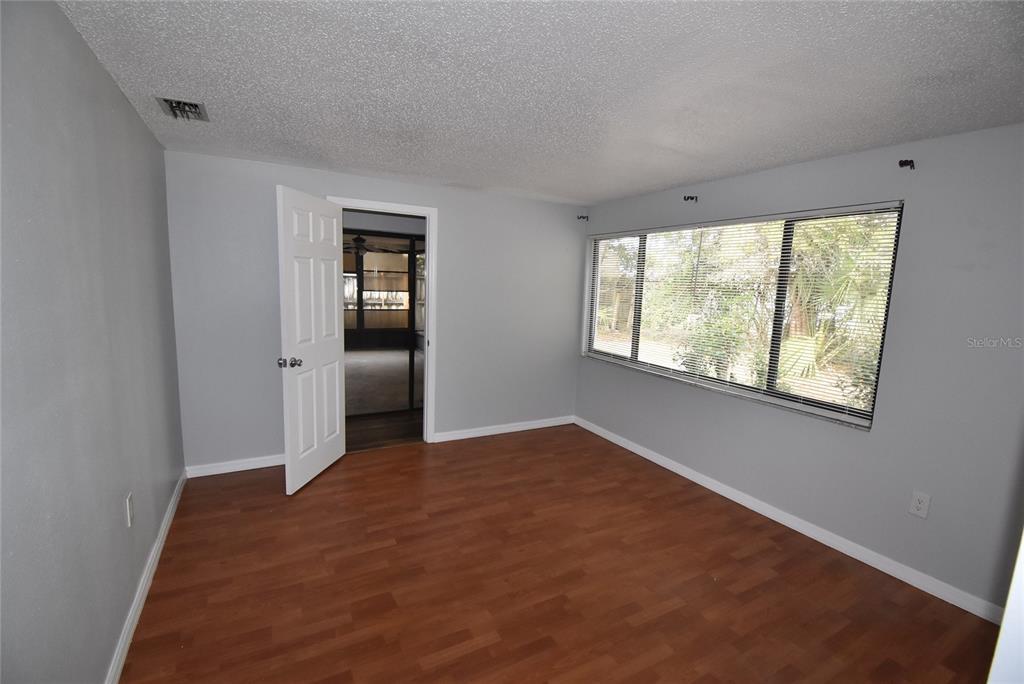 7615 Karen Drive Port Richey, FL 34668 - Photo 12 of 24 an empty room with windows and closet