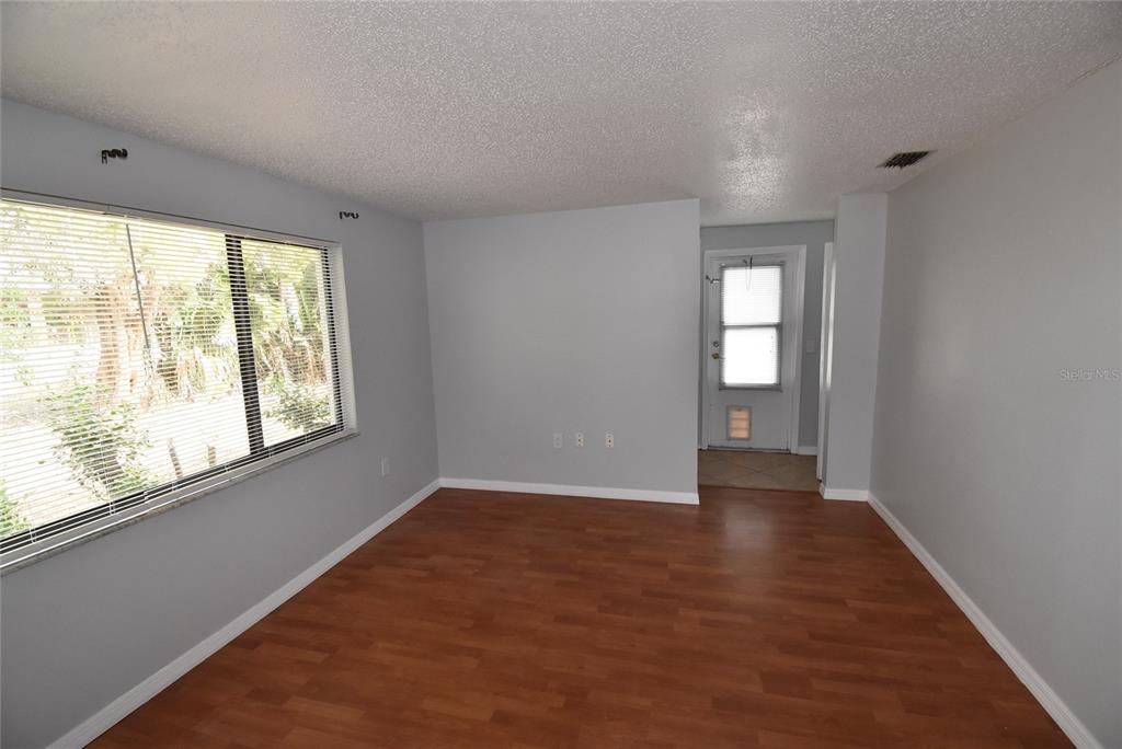 7615 Karen Drive Port Richey, FL 34668 - Photo 14 of 24 an empty room with wooden floor and windows