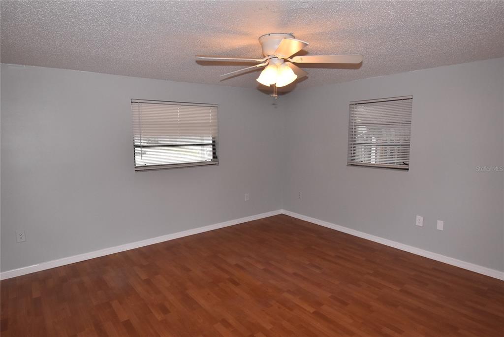 7615 Karen Drive Port Richey, FL 34668 - Photo 16 of 24 a view of an empty room with wooden floor and a window