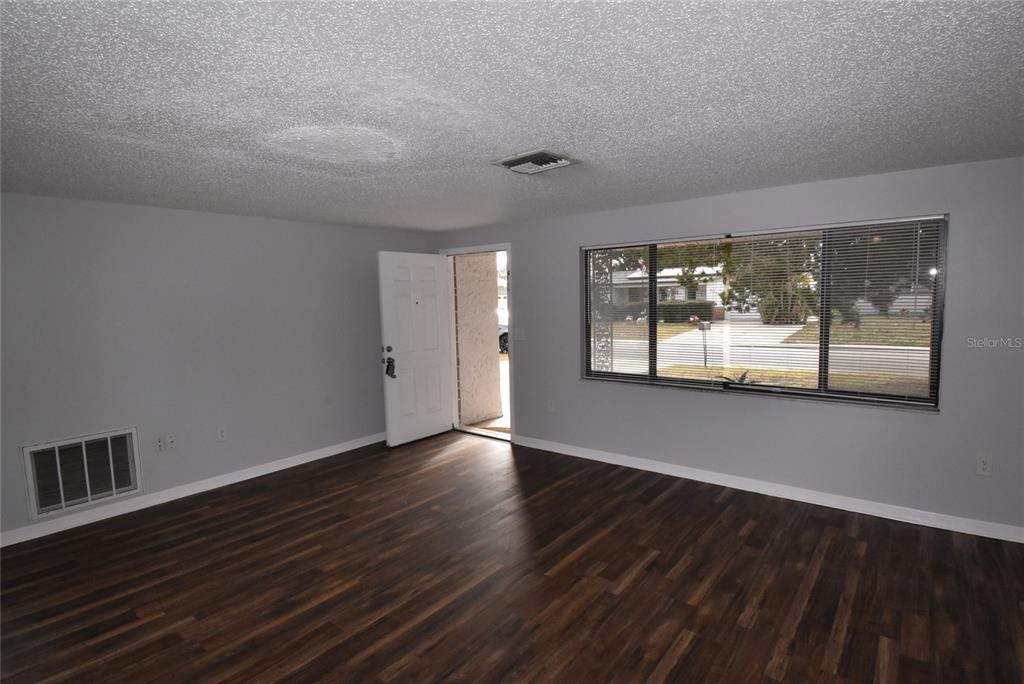 7615 Karen Drive Port Richey, FL 34668 - Photo 20 of 24 a view of an empty room with wooden floor and a window