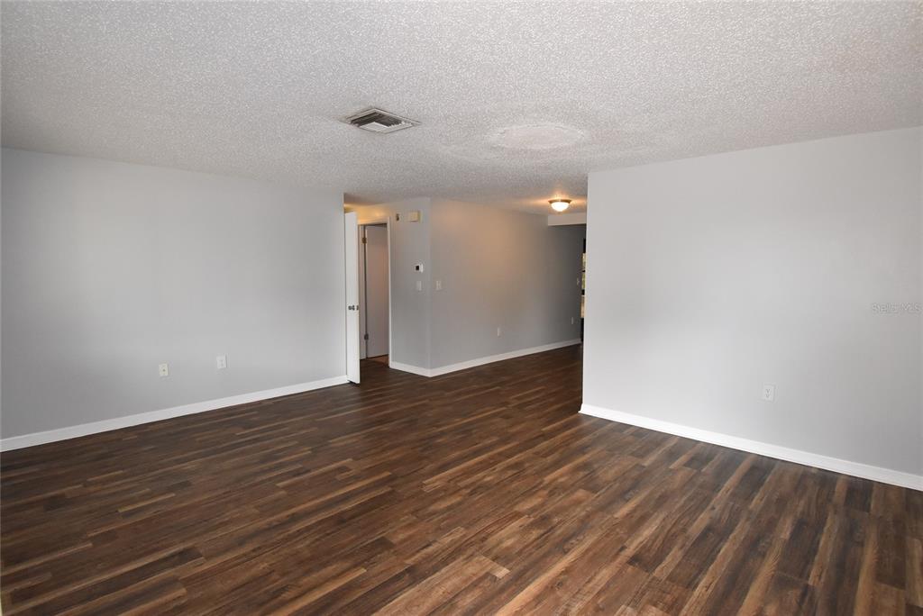 7615 Karen Drive Port Richey, FL 34668 - Photo 3 of 24 a view of an empty room with wooden floor