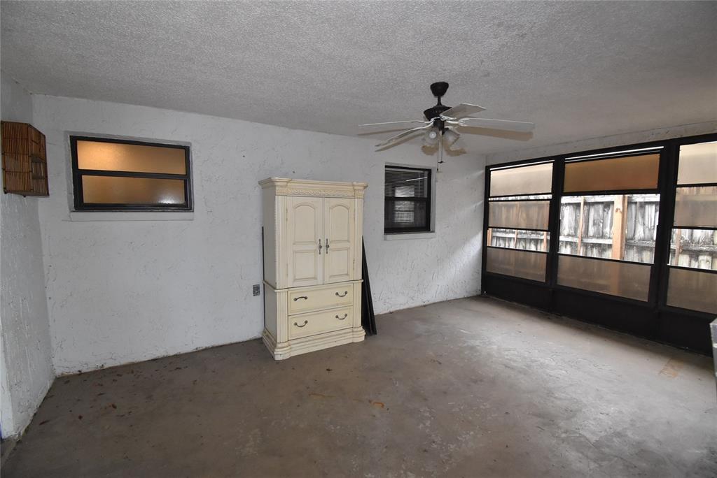 7615 Karen Drive Port Richey, FL 34668 - Photo 7 of 24 an empty room with windows and ceiling fan