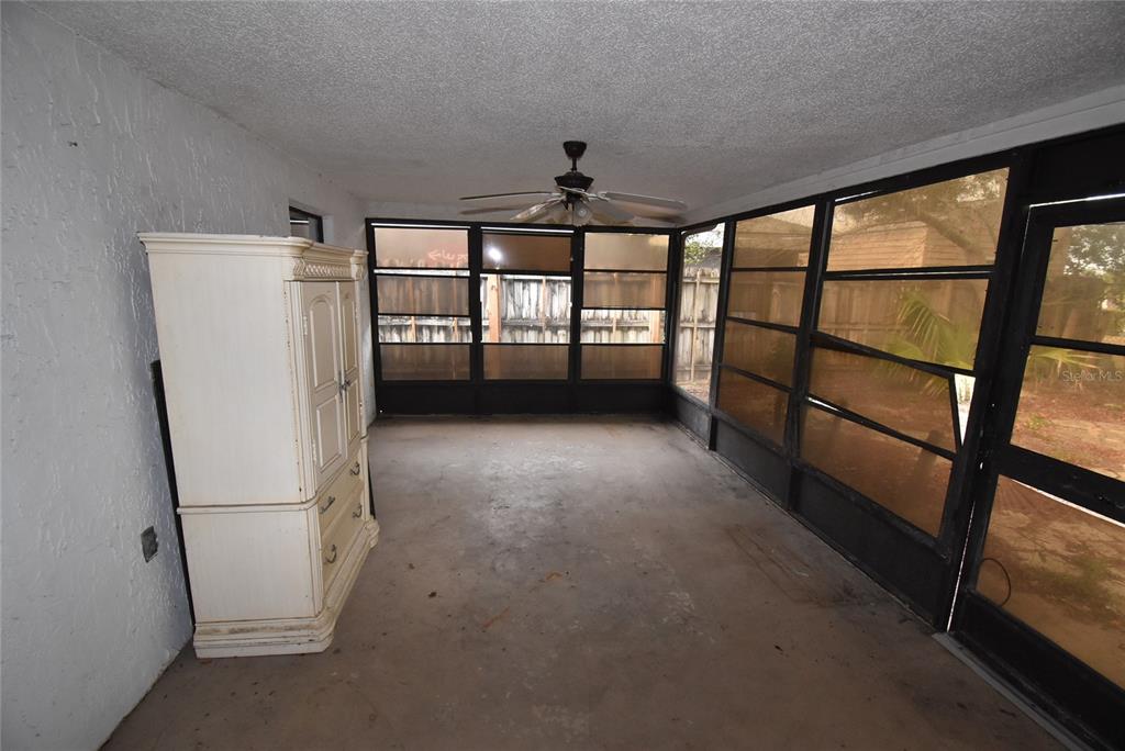 7615 Karen Drive Port Richey, FL 34668 - Photo 8 of 24 a view of entryway with an empty room and a ceiling fan