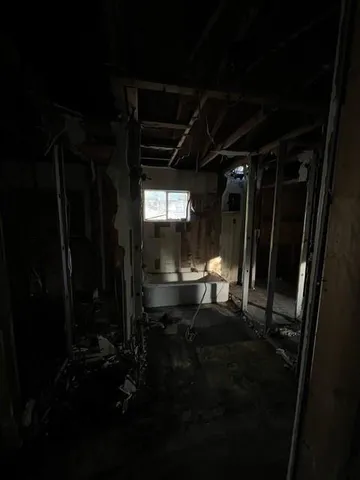 a room with water heater and wooden floor