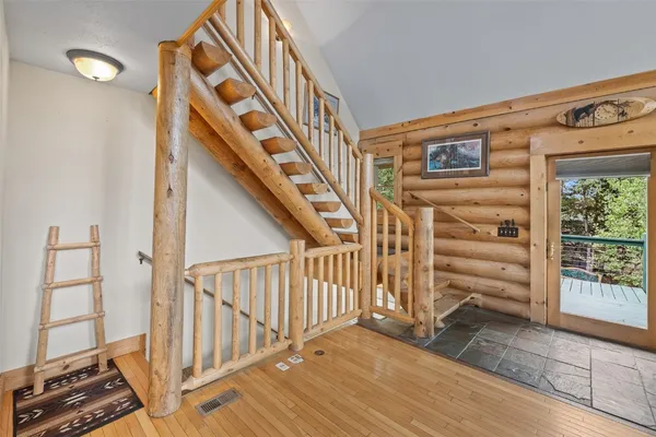 a view of staircase with wooden floor and windows