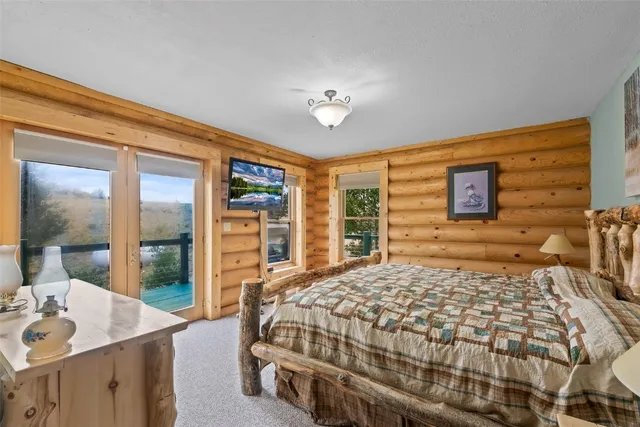 a bedroom with a large bed and a dresser