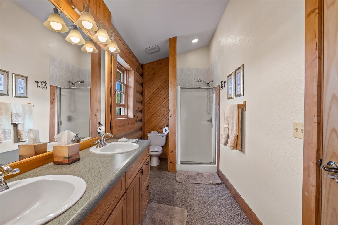 486-432 Turk Pony Way Como, CO 80456 - Photo 23 of 49 a bathroom with a sink double vanity granite and a mirror