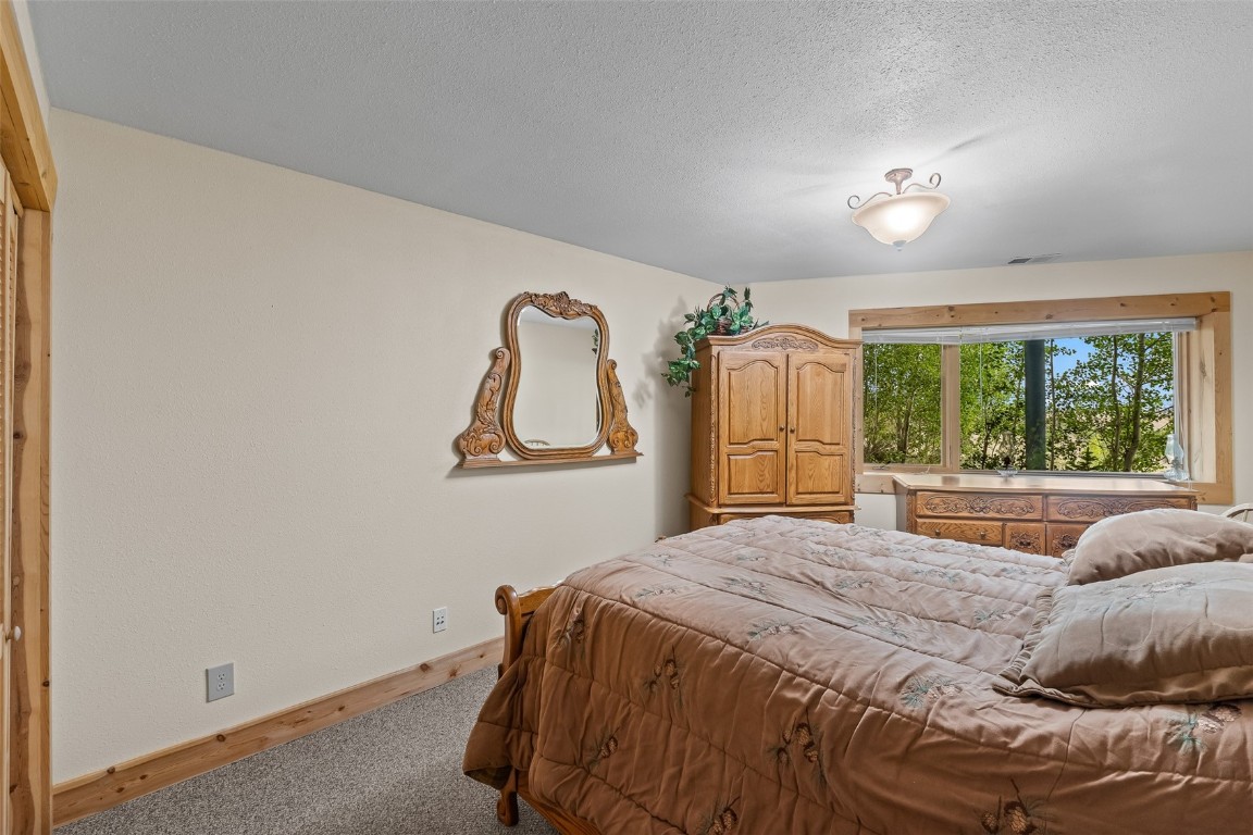 486-432 Turk Pony Way Como, CO 80456 - Photo 27 of 49 a bedroom with a large bed and a window
