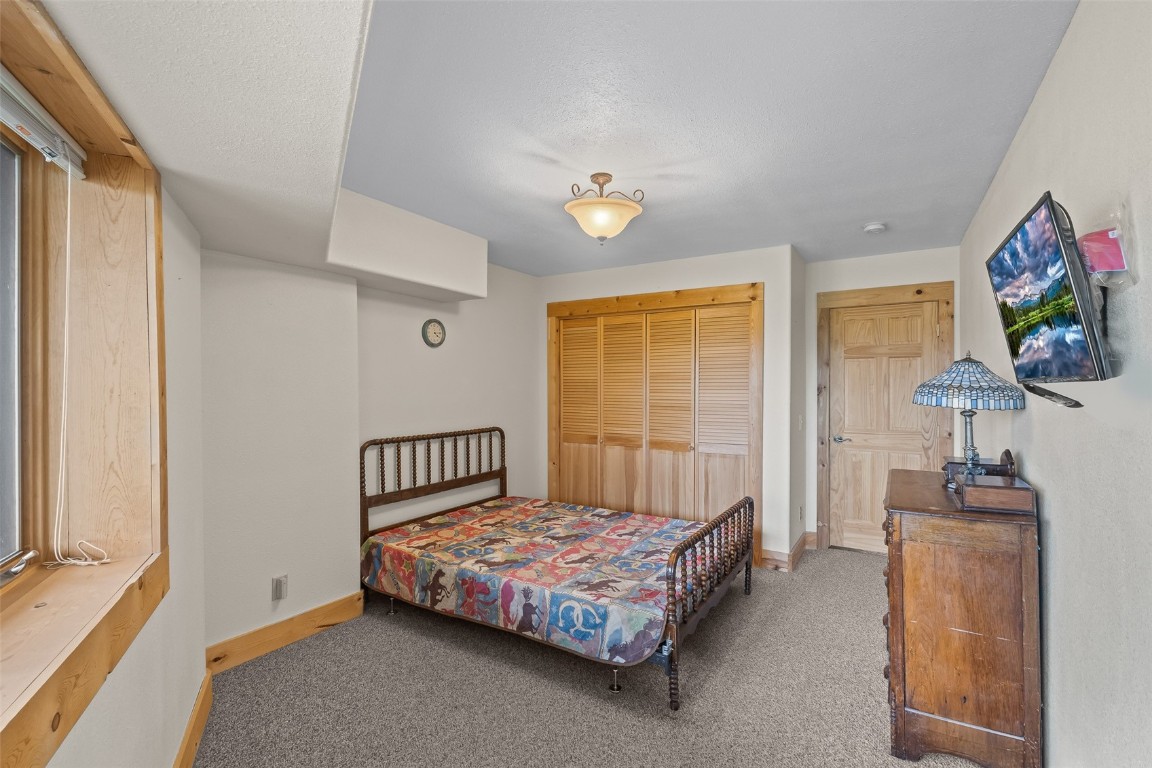 486-432 Turk Pony Way Como, CO 80456 - Photo 29 of 49 a bedroom with a bed and a flat screen tv