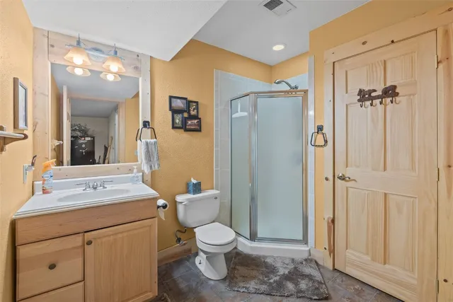a bathroom with a toilet sink shower and mirror