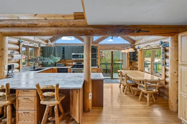 a dining room with furniture and wooden floor