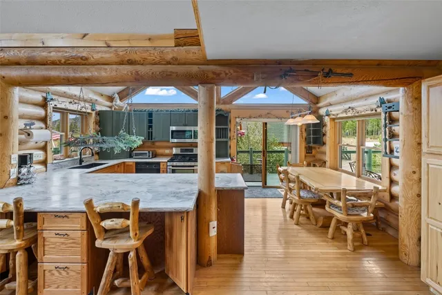 a dining room with furniture and wooden floor