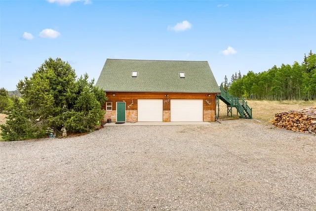 a view of a house with a yard and garage