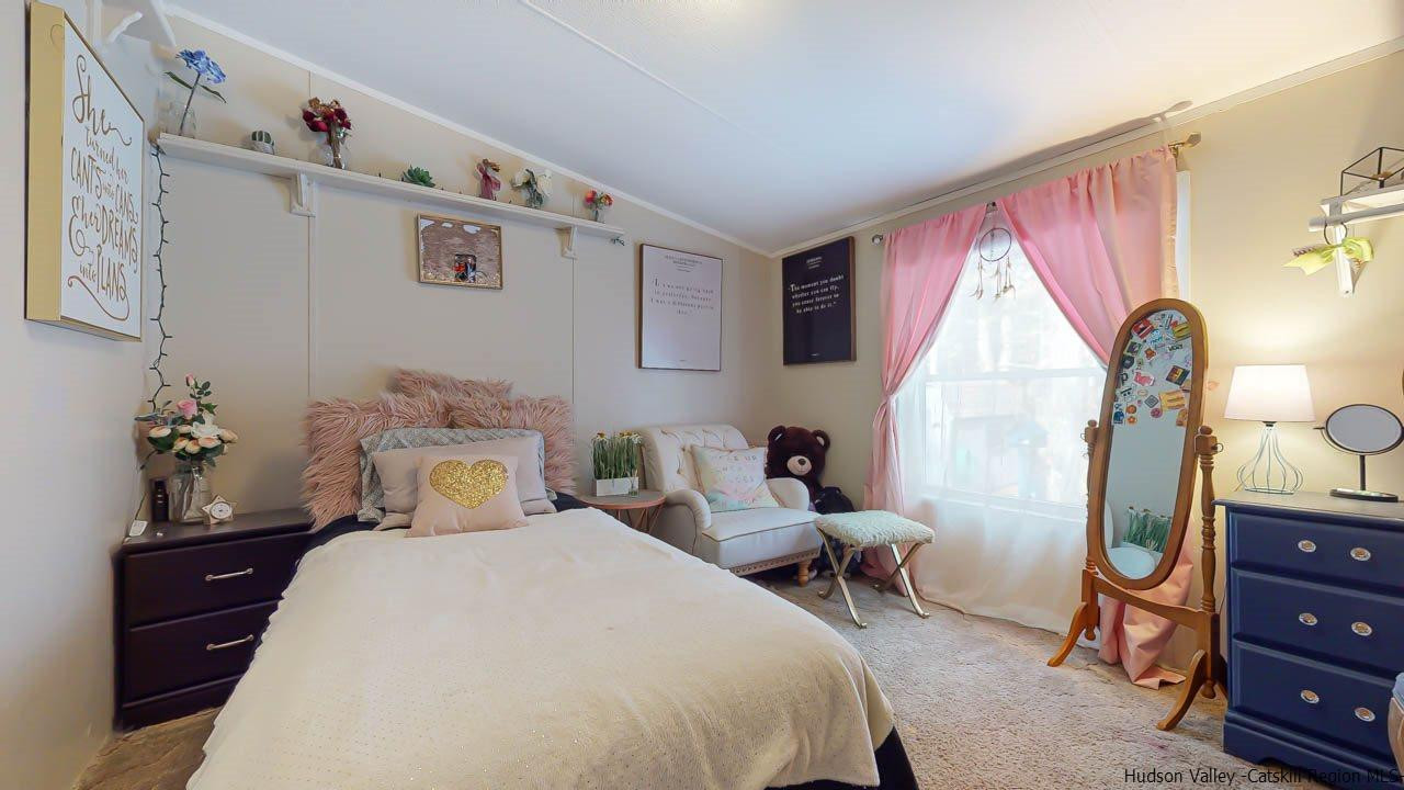 271 Scarawan Road Stone Ridge, NY 12484 - Photo 18 of 27 a bedroom with a bed and wooden floor