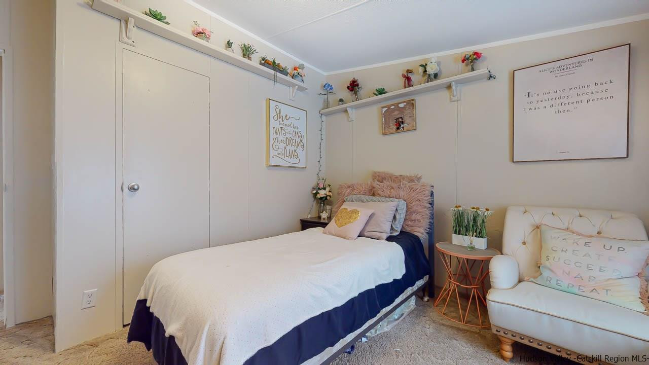 271 Scarawan Road Stone Ridge, NY 12484 - Photo 20 of 27 a bedroom with a bed and a couch