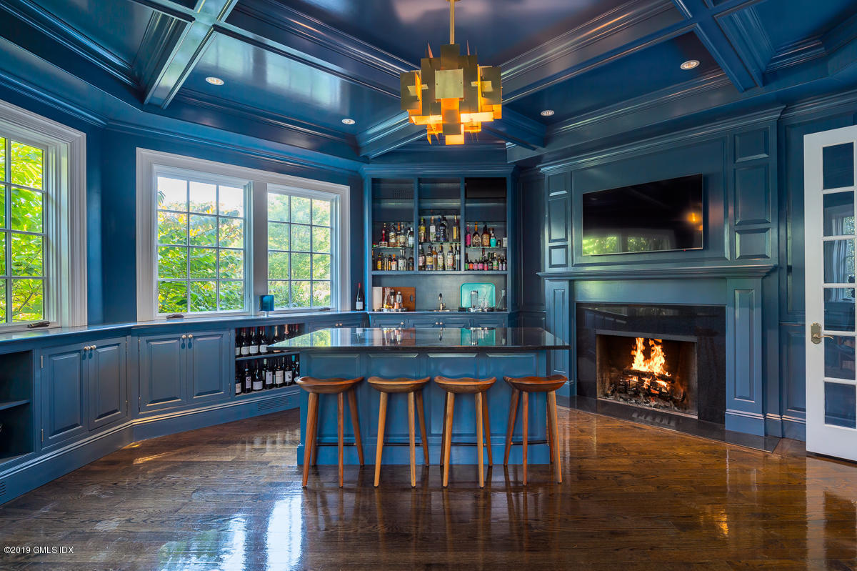 170 Old Mill Road Greenwich, CT 06831 - Photo 11 of 42 a kitchen with stainless steel appliances granite countertop a table chairs and a fireplace