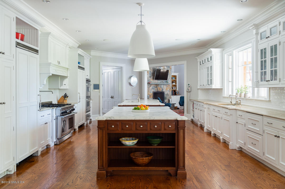 170 Old Mill Road Greenwich, CT 06831 - Photo 16 of 42 a kitchen that has a lot of cabinets in it and wooden floors