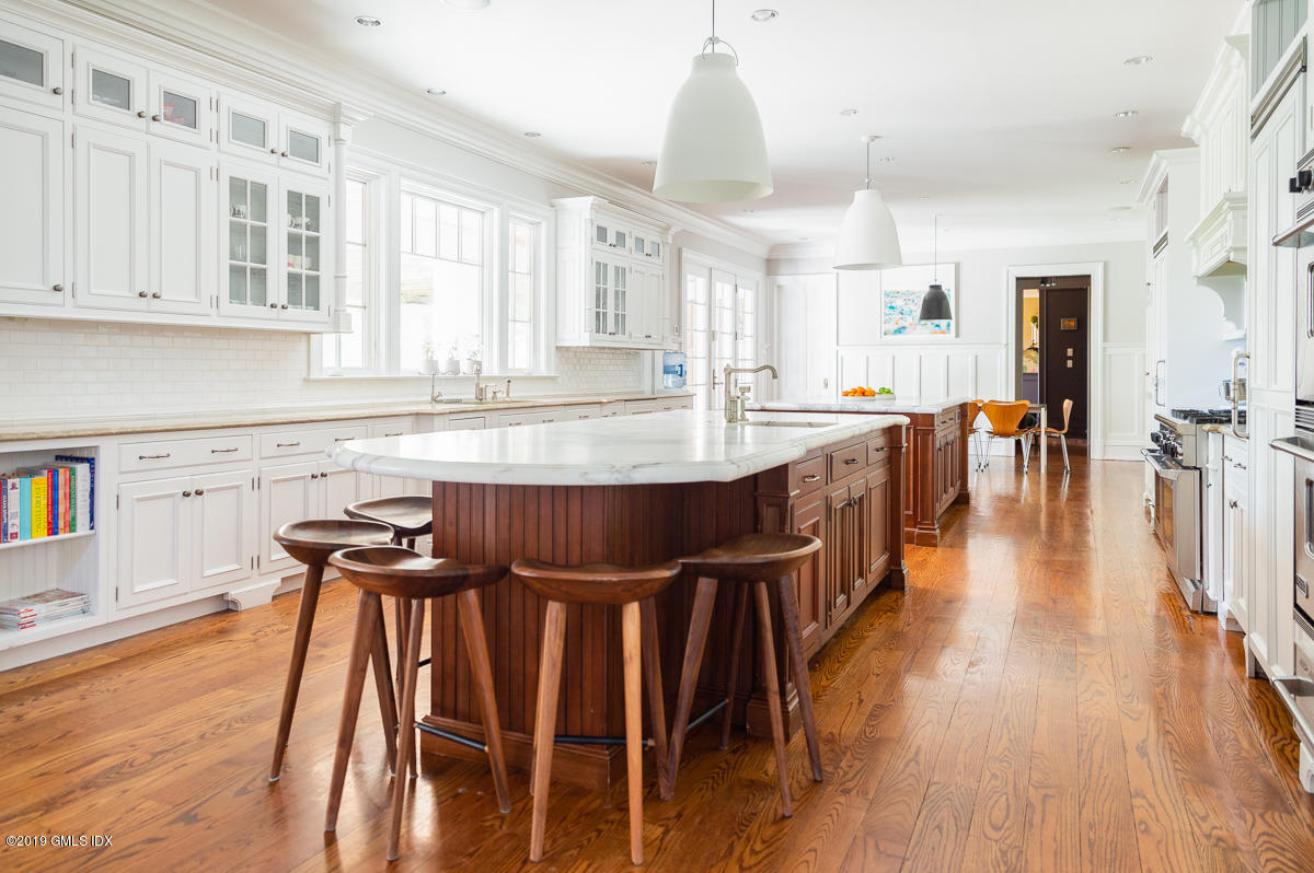170 Old Mill Road Greenwich, CT 06831 - Photo 17 of 42 an open kitchen with wooden floor and stainless steel appliances