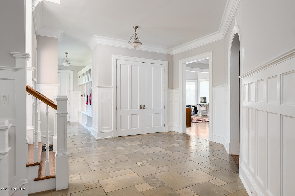 170 Old Mill Road Greenwich, CT 06831 - Photo 19 of 42 a view of a hallway with wooden floor and a living room