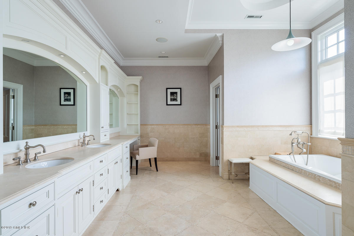 170 Old Mill Road Greenwich, CT 06831 - Photo 22 of 42 a spacious bathroom with double vanity sinks a large mirror and a bathtub